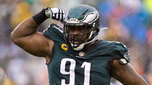 Eagles defensive tackle Fletcher Cox flexes after sacking Trevor Lawrence in a game.